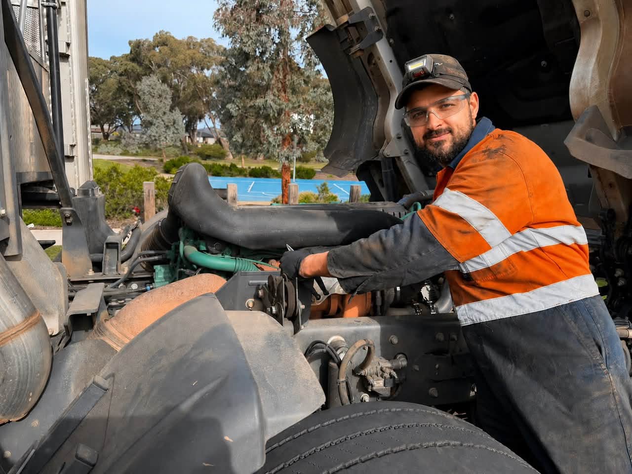 Omer Subhe, founder of Evolve Mechanical Services, servicing a heavy truck engine on site